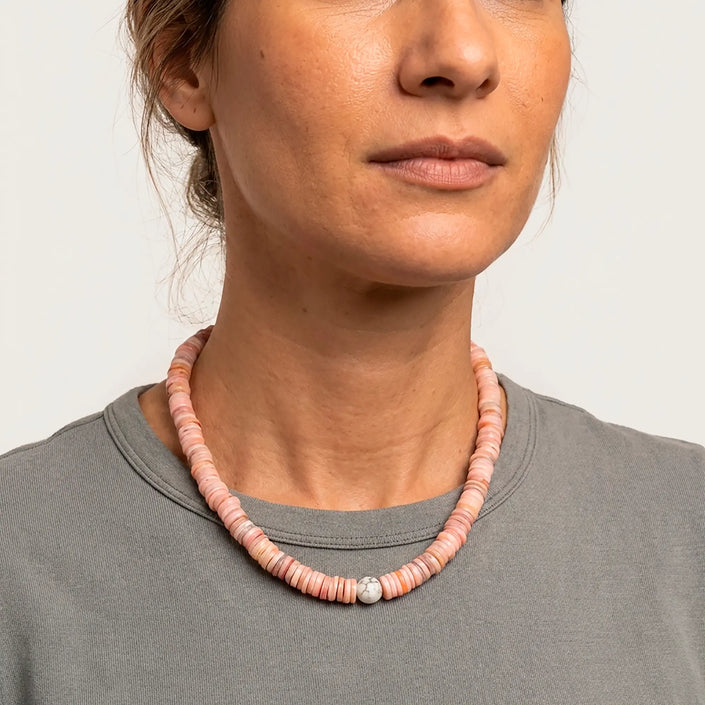 Koralli shell disc necklace in coral tones worn with grey top