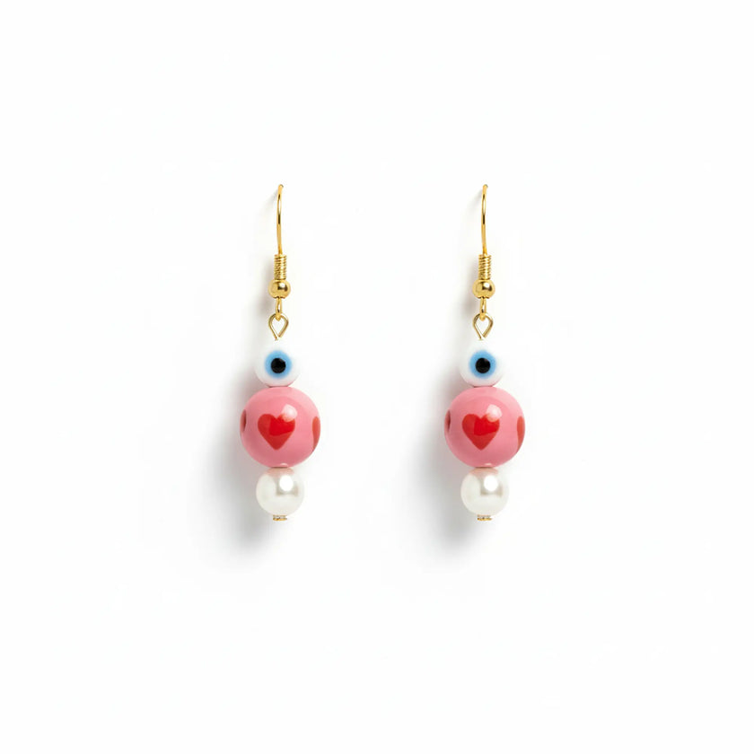 Handmade earrings from Naxos with pink heart beads, evil eye detail, and pearl drops