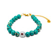 Handmade turquoise bracelet from Naxos with central evil eye bead and gold plated adjustable clasp