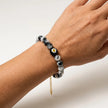 Woman wearing a black and white marbled stone bracelet with Murano flower bead