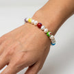 Woman wearing a handmade pearl bracelet with colorful glass accent beads