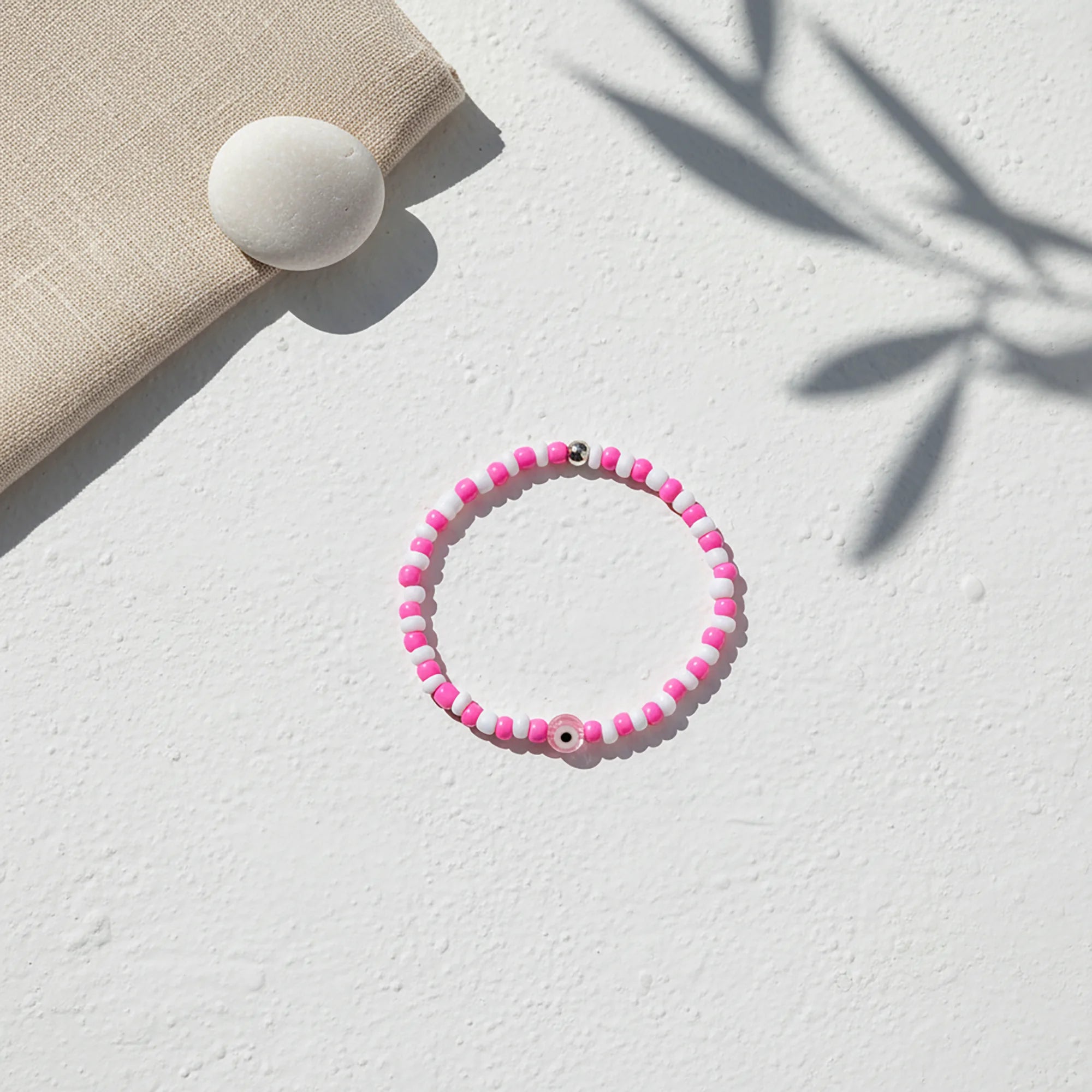 Handmade pink evil eye bracelet from Naxos with pink and white beads