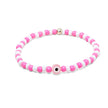 Stretch bracelet with pink and white beads and small pink evil eye centerpiece