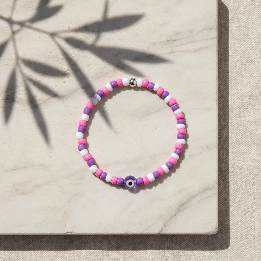 Handmade pink purple and white seed bead bracelet with purple evil eye centrepiece, Naxos