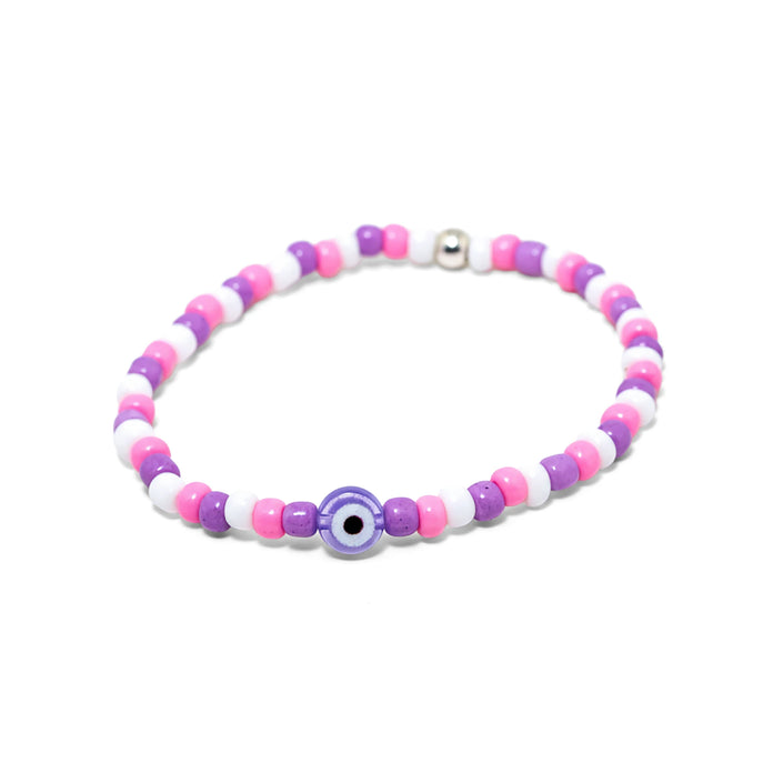 Close-up of a stretch seed bead bracelet in pink purple and white with evil eye centrepiece