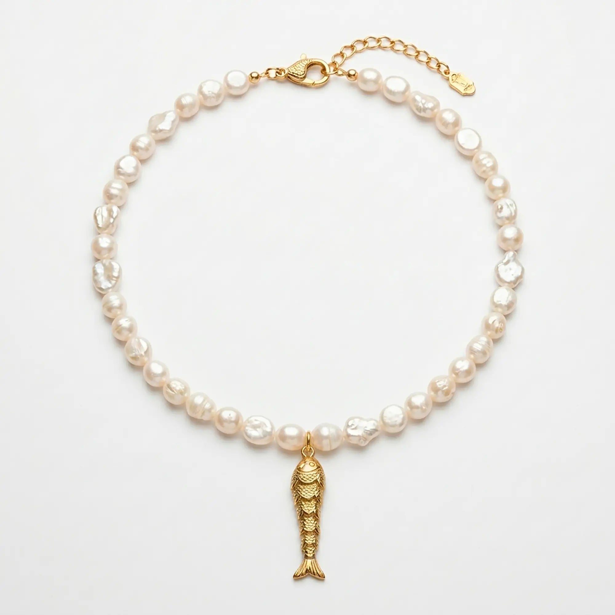 Psari pearl necklace with gold plated fish pendant flat lay on white background