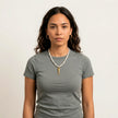 Psari freshwater pearl necklace with gold fish pendant worn with grey t shirt