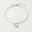 Selini freshwater pearl necklace with shell clover pendant flat lay