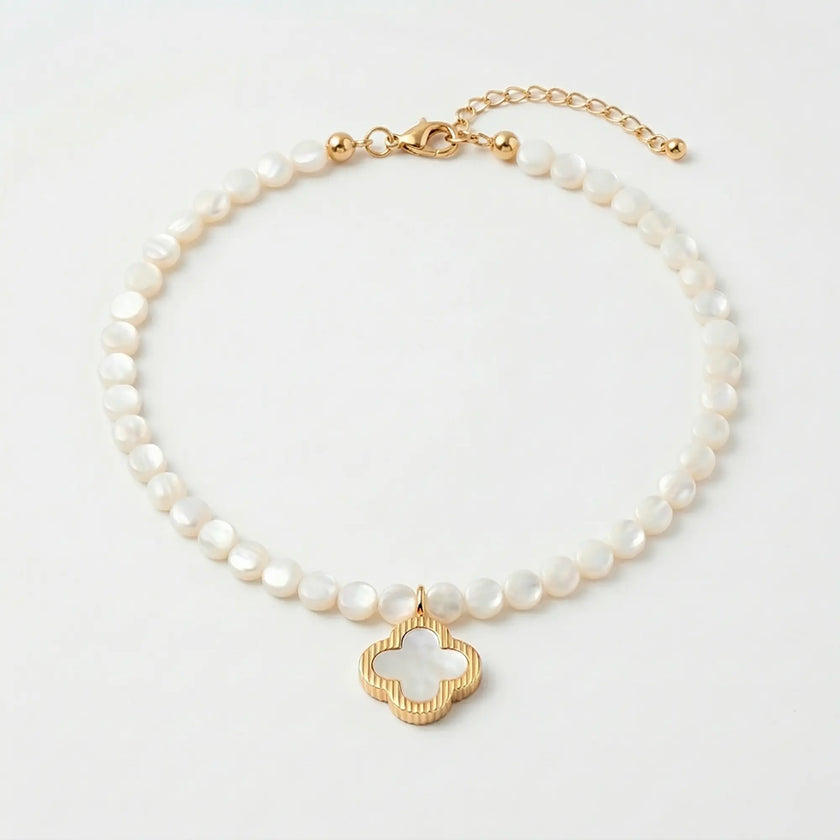 Selini freshwater pearl necklace with shell clover pendant flat lay