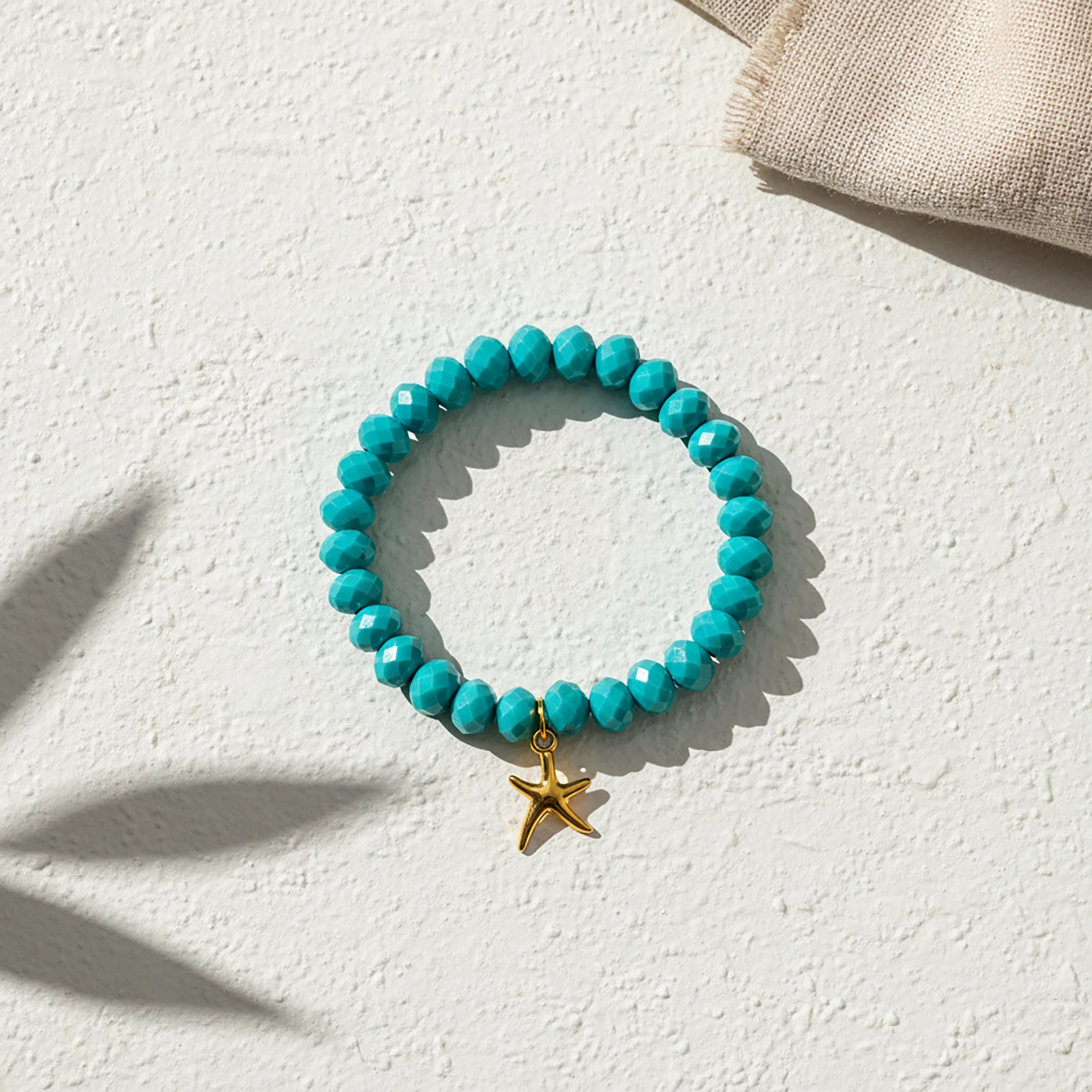Handmade turquoise bracelet from Naxos with faceted beads and gold starfish charm
