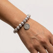 Close up of thaleia coin charm bracelet